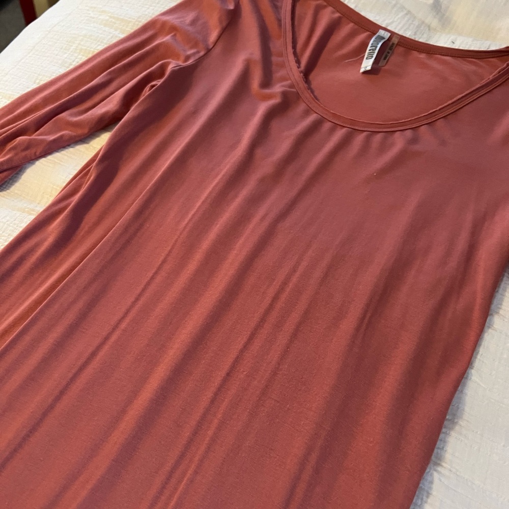 A symmetrical dress at bottom with half sleeve